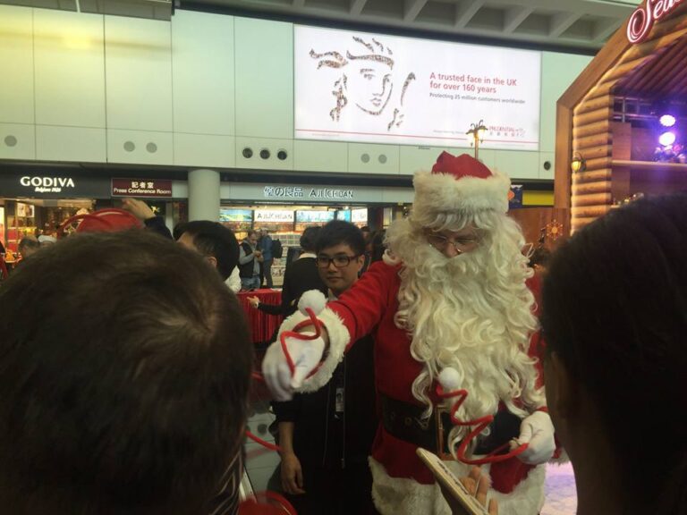 The Santa performer in HK giving out Christmas giveaway at the Hong Kong airport Xmas Event.