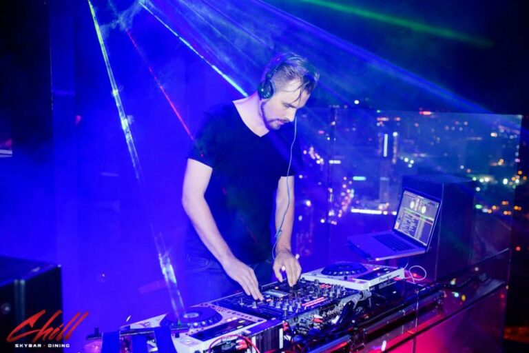 Professional DJ Pure MB makes music in Hong Kong under blue light