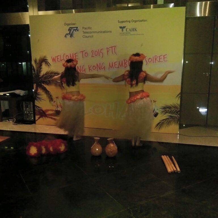 2 dancers doing the hula in front of backdrop for event in Hong Kong