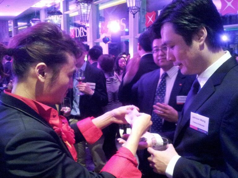 Hong Kong Magician performing roving card magic at DBS Hong Kong cocktail party