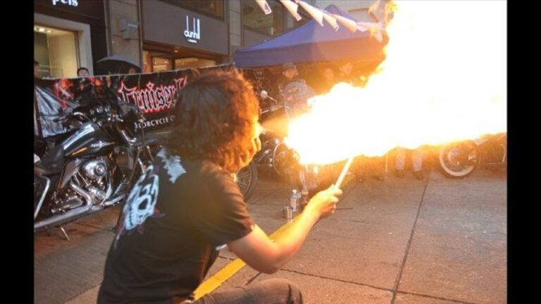 HK fire juggler Breathing fire at a corporate street show