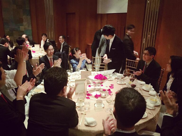 Magician in Hong Kong performing table magic with cards to a lady at a corporate annual dinner