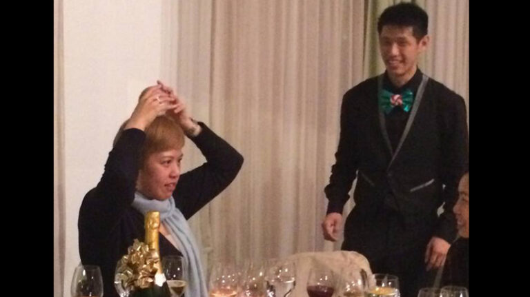 Hong Kong roving juggler teaching a guest to do the crystal ball trick at an annual dinner
