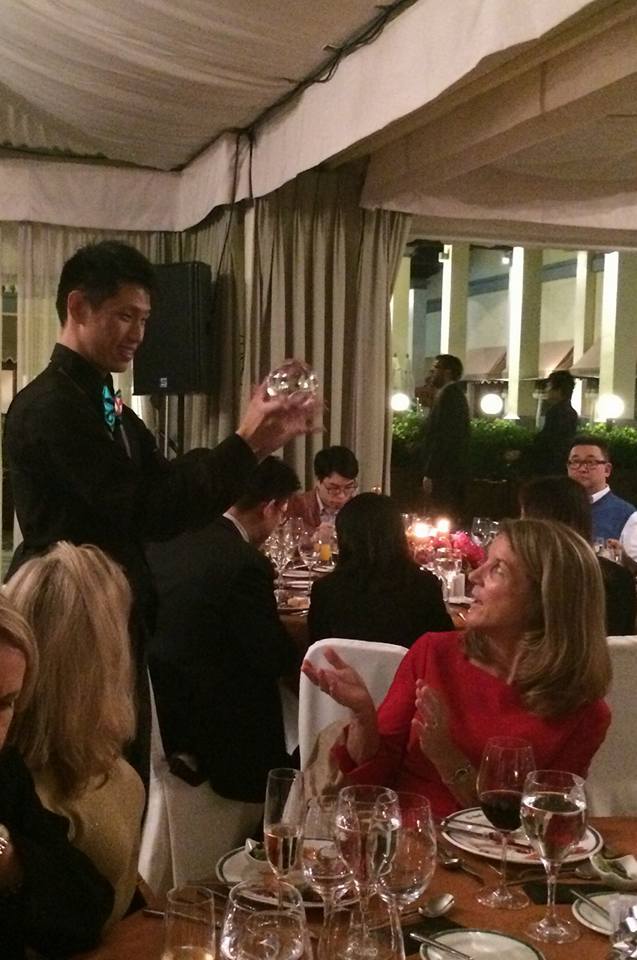 Walk around juggler showing the crystal ball tricks to the client at annual party