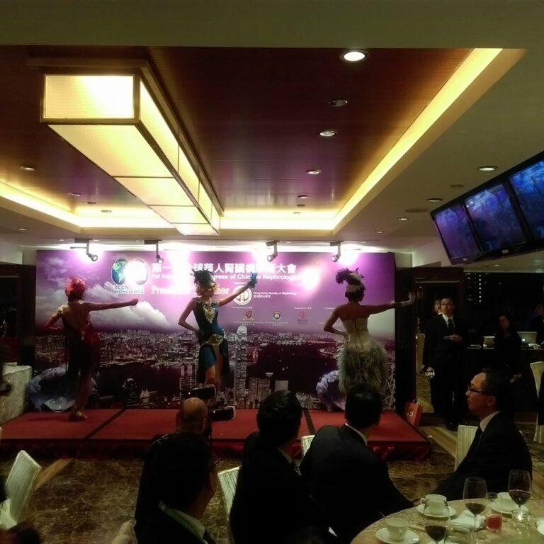 3 dance posing in front of backdrop