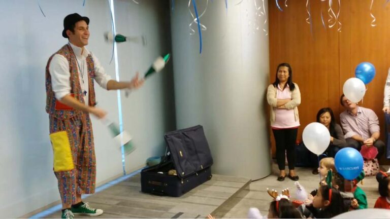 Roving juggler in HK juggling three cups at a corporate xmas event