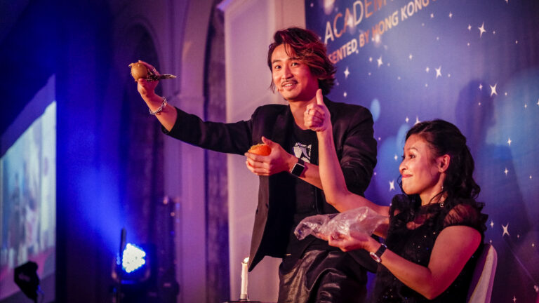 Hong Kong Magician impressed a guest by performing a stage magic with fruit at a corporate event