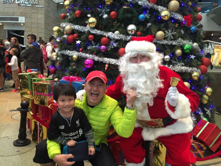 Santa standing infront of giant tree