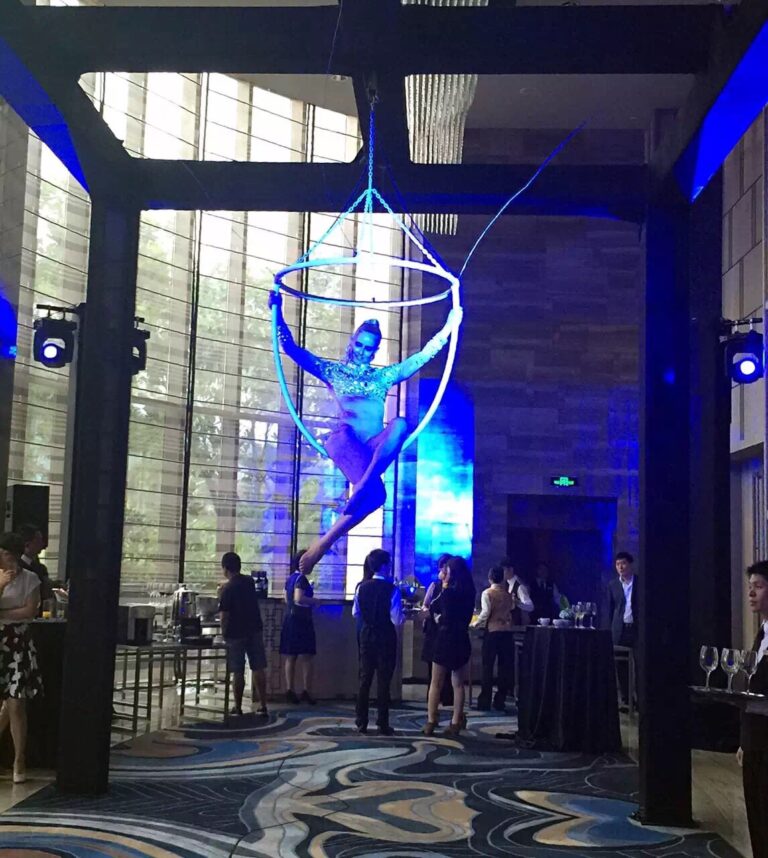 Aerial Champagne performer in HK posing on a huge ring at a fashion function at Hilton Hotel