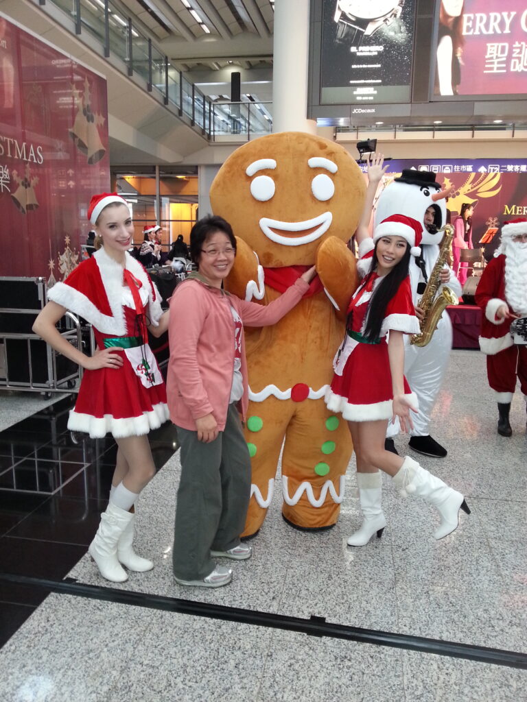 2 models standing with gingerbread man in Hong Kong