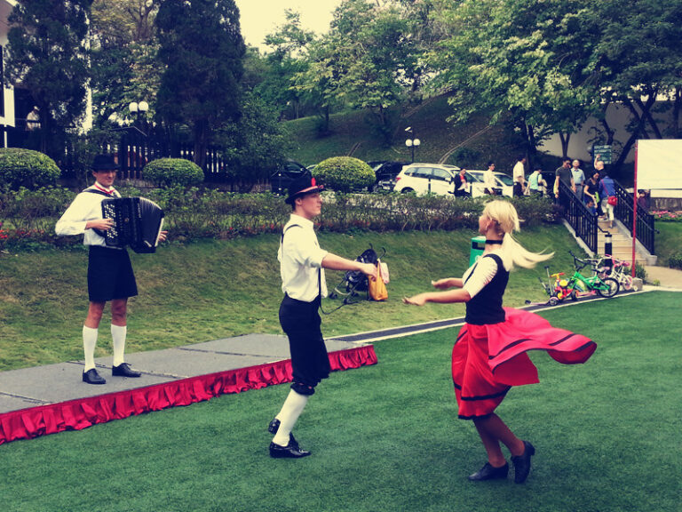 German dancing pair at a park in Hong Kong performing with music