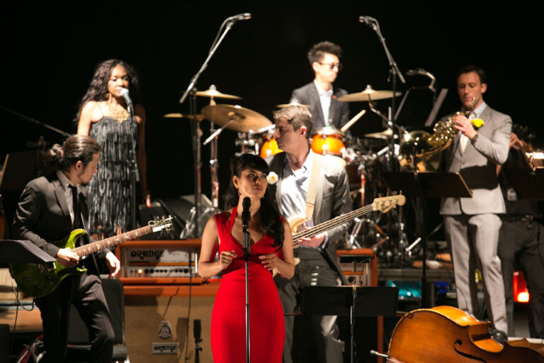 Vocalist with band performing fusion pop music