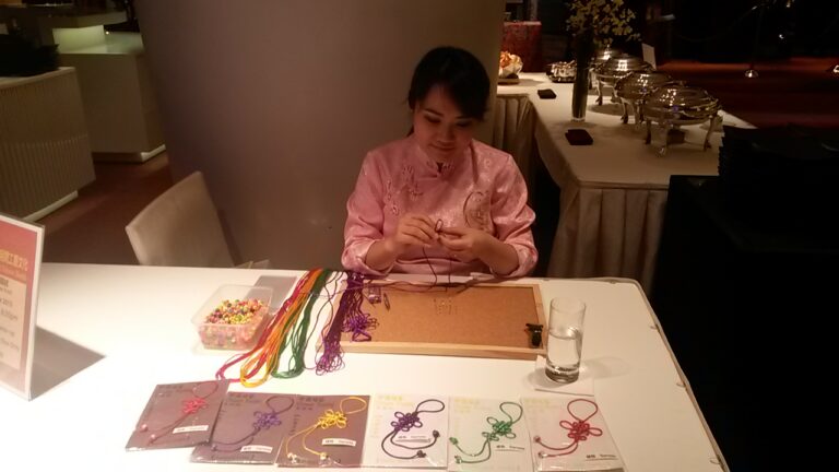 Hong Kong artist knitting Chinese knotting at a corporate event