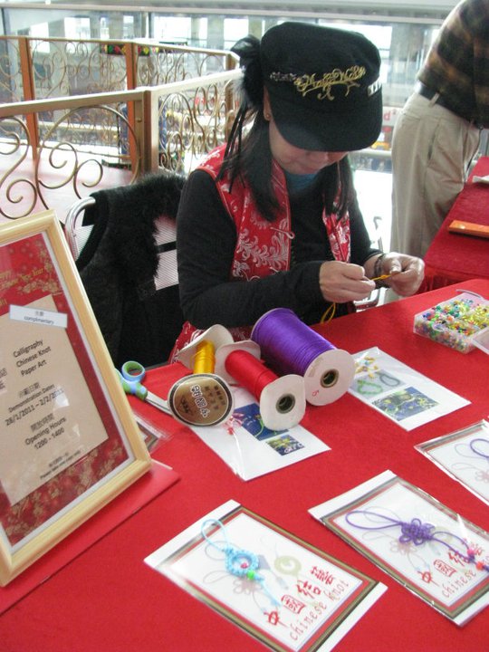 A Hong Kong Chinese knot artist knitting at a corporate CNY event