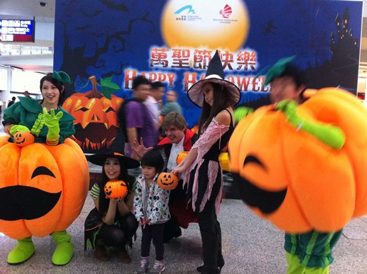 Model and pumpkin mascot with Halloween backdrop