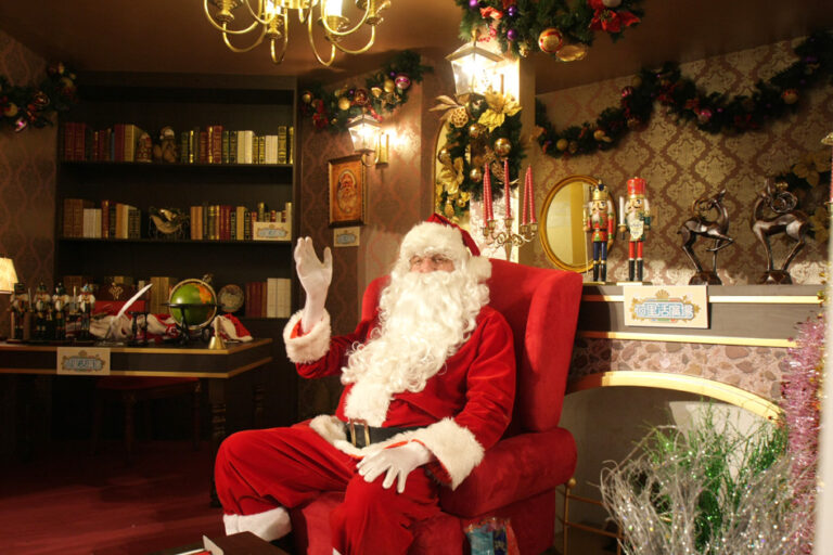 hong kong santa waving in his a regal style room grotto