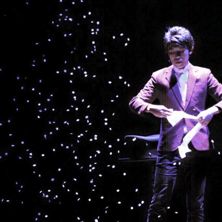 Magician in HK performing stage magic snow storm with white paper at corporate event.