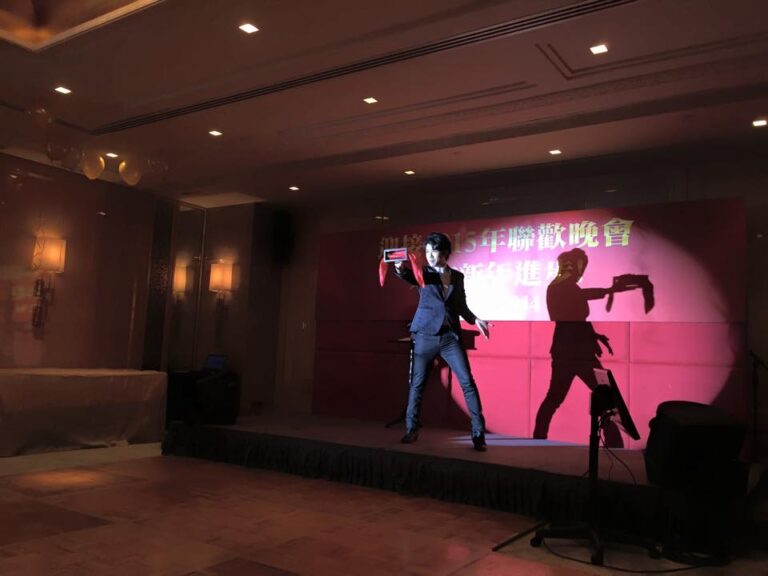 Magician performing stage magic with a box and silk at a Hong Kong corporate annual dinner