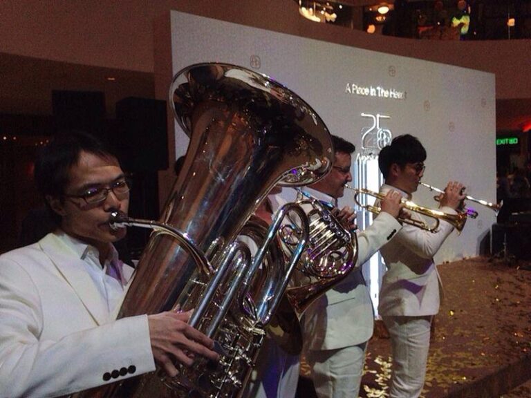 band featuring trumpet and horn performing in white suits