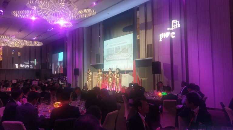 4 girls in gold costume performing on stage