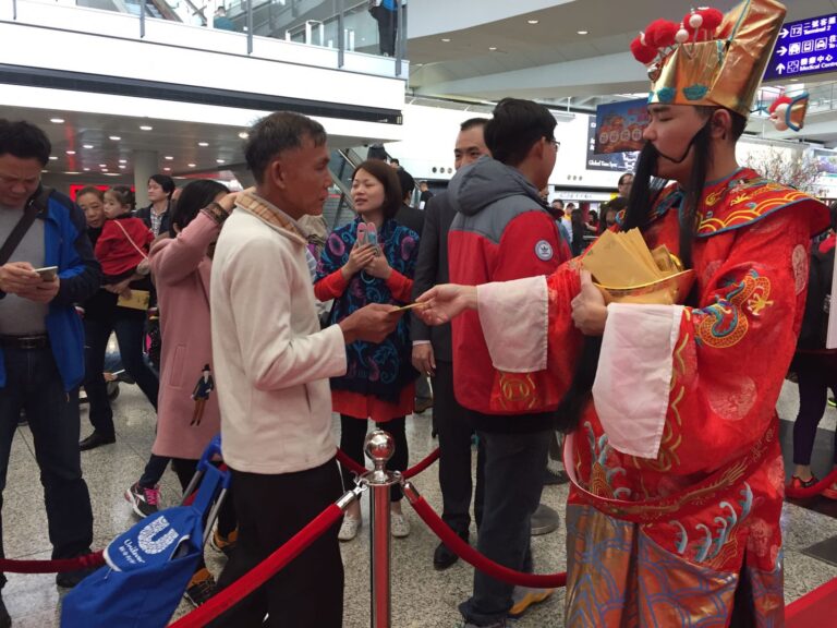 Danny Choi Sun at Airport with guests taking red packet