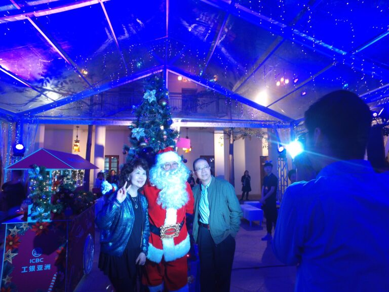 Santa taking photo in marquee.