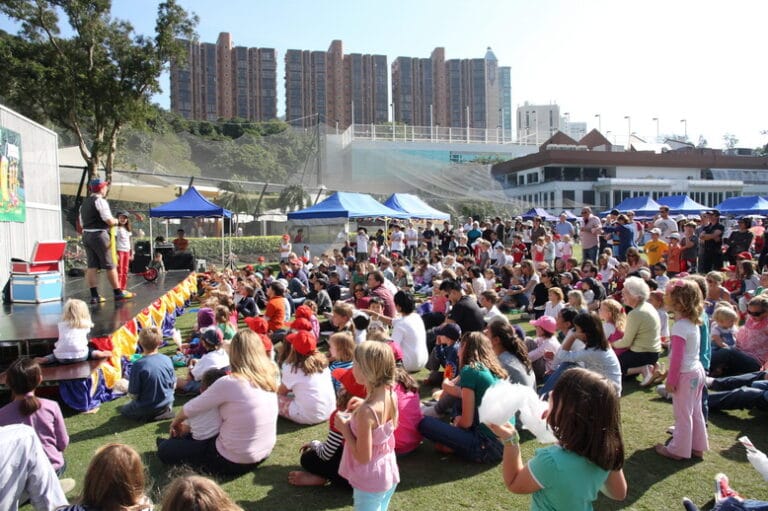 Magician Juggler at the Hong Kong cricket club doing a stage with a huge family crowd seated in front