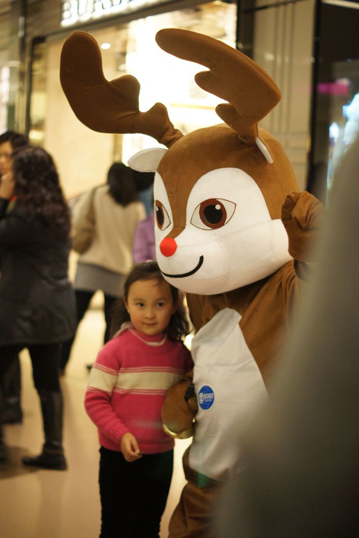 Reindeer mascot strolling with shoppers at shopping centre in Hong Kong