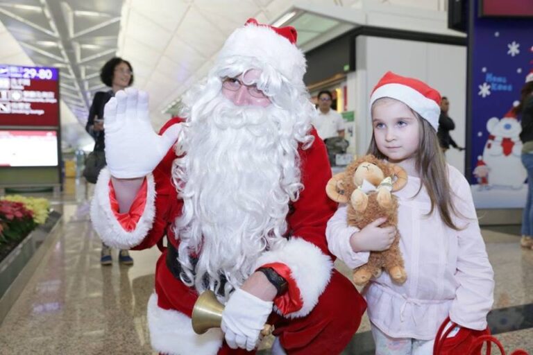 Santa Dave C in Hong Kong international Airport with a young fan