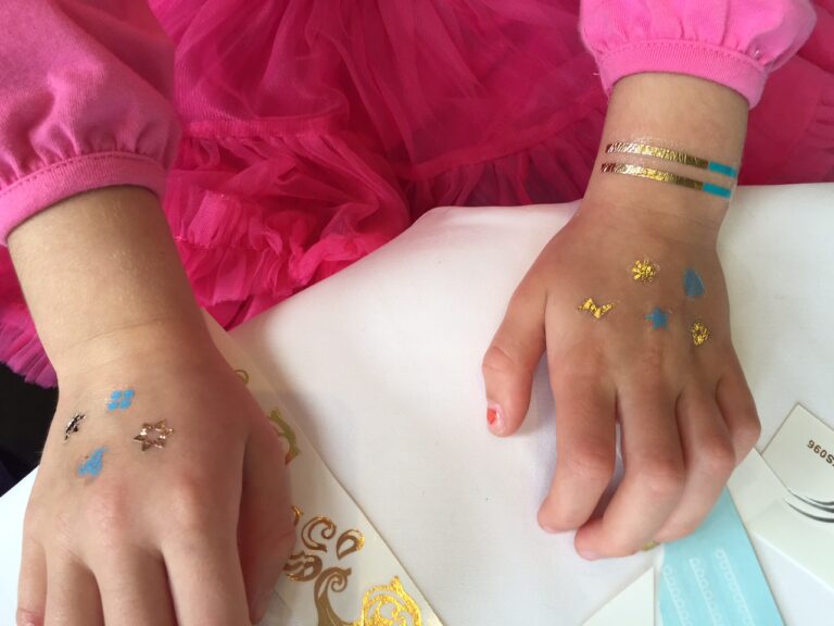 A Hong Kong Kid have ten henna style temporary tattoos on her hands at a family function