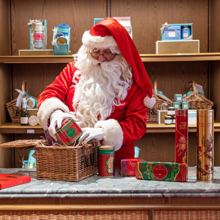 Santa Hugh packing picnic basket with F&M logo on