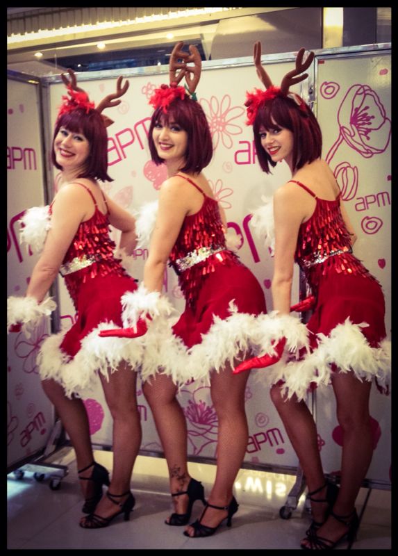 Three reindeer girl dancers in Hong Kong posing at the APM shopping mall Christmas event