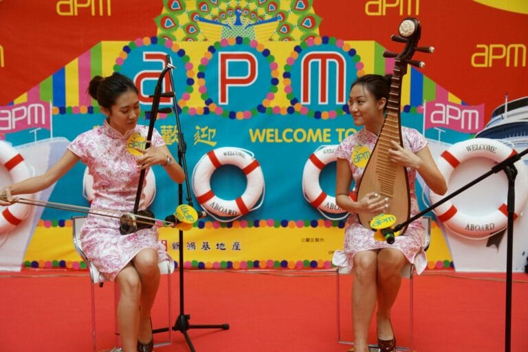 Two HK Chinese music musicians playing Erhu and Pipa at a shopping mall event