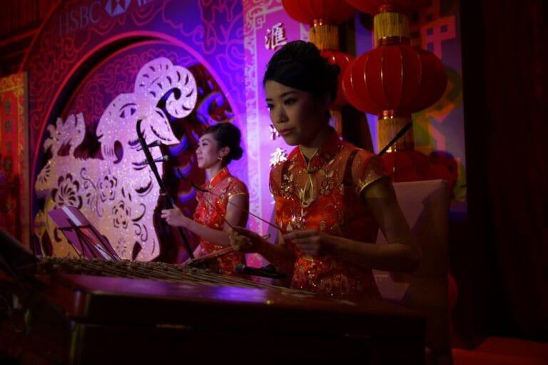 Two Chinese music musician playing Erhu and Yangqin at a Hong Kong Bank annual dinner