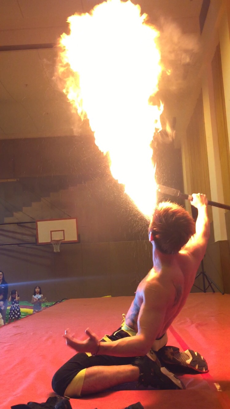 HK Fire juggler performing breathing fire act a festival event