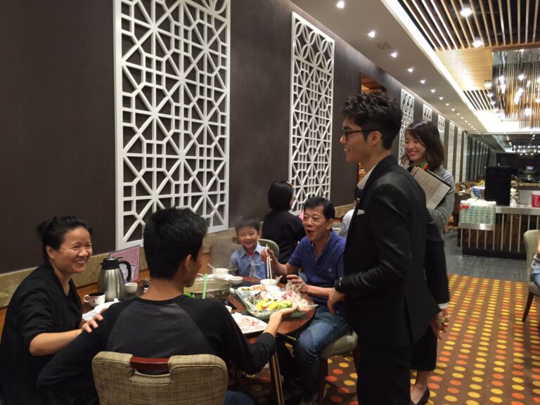 Magician in Hong Kong performing roving table magic for a family to promote the new menu at a restaurant