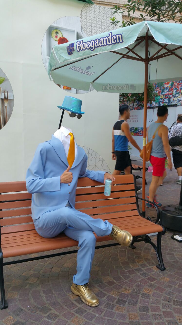 Hong Kong living statue performer in headless man costume at Lee Tung Avenue.
