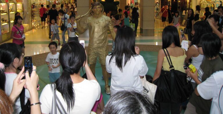 Living statue tennis player performing in the mall