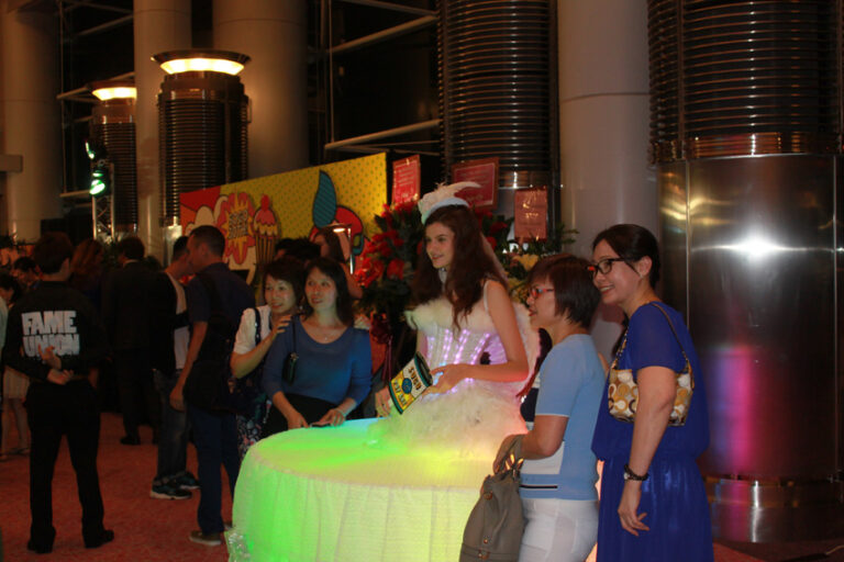 A lady dressed as a living table for corportate entetainment having picture taken of her