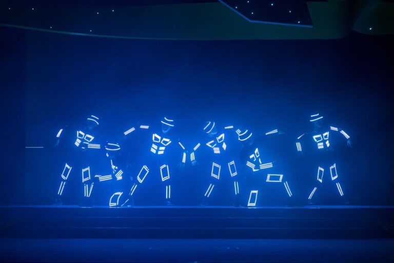 blue outfit dancers in LED costumes