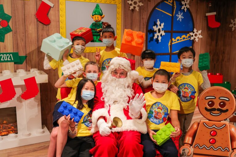 santa in red costme with children wearing yellow tops in tsim tsai tsui in Hong Kong