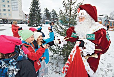 Local Santa Mario in Finland handing out gifts to kids