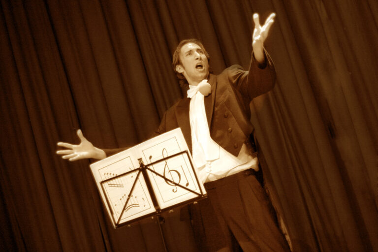 A Kong Kong stage magician performing his comedy musical magic show at a corporate annual dinner