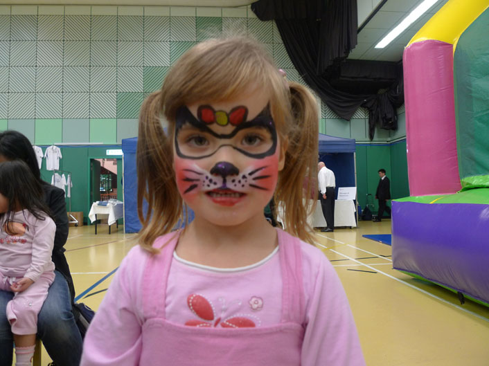 A little girl in HK got her face paint as a kitten by a face painter at a Hong Kong
corporate function in HKFC.