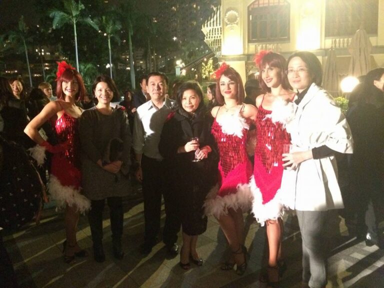 Three Hong Kong Dancers dress as Reindeer girls taking picture with the guests after the dance performance at a corporate Christmas event