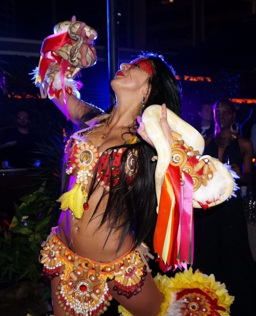 A Dancer in HK dancing with two snake at a cocktails event