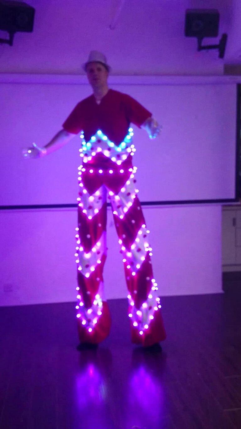 Stiltwalker in a LED costume posting at a studio in Hong Kong