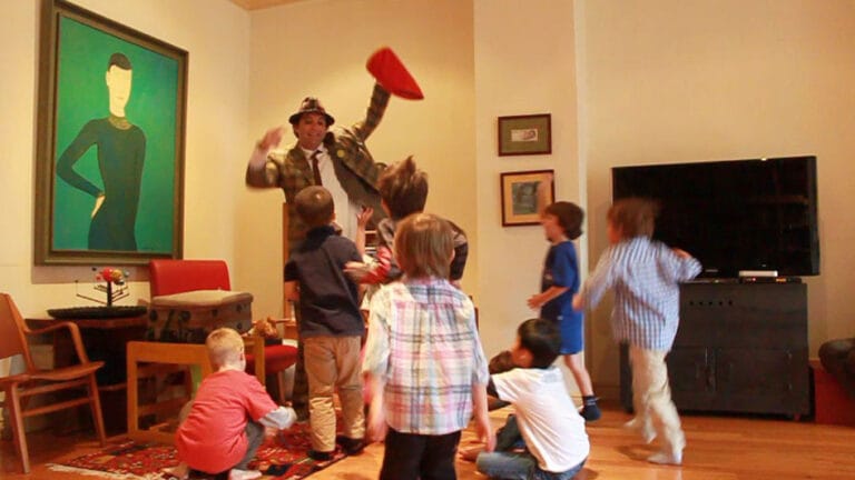 Hong Kong juggler holding a red bag going to give out candies to the kids at the birthday party
