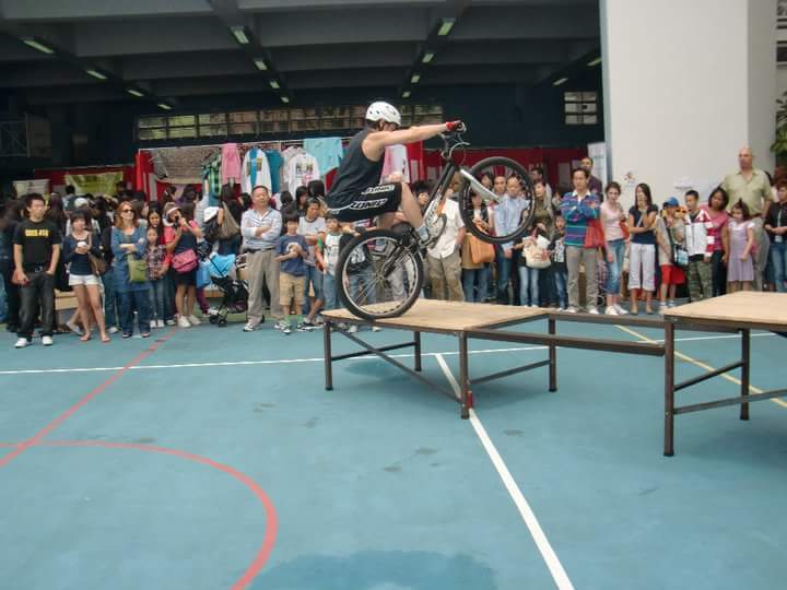 A Professional Trial Bike performer in Hong Kong doing a series breathtaking action at a corp family fun day event