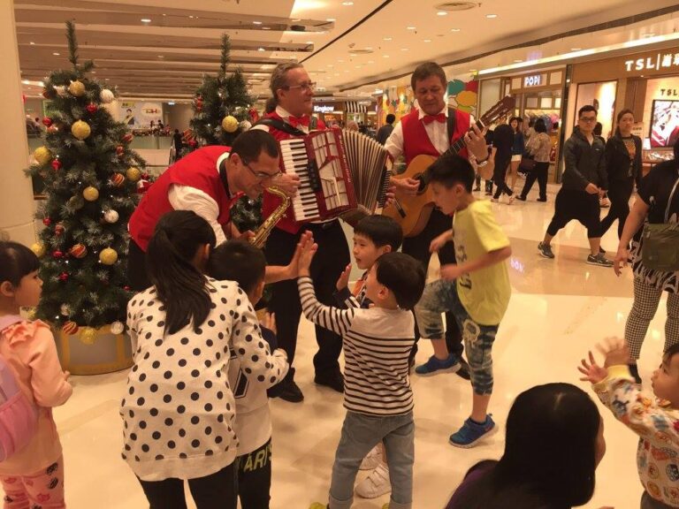 Musicians in red vest playing in mall in Hong Kong 2015